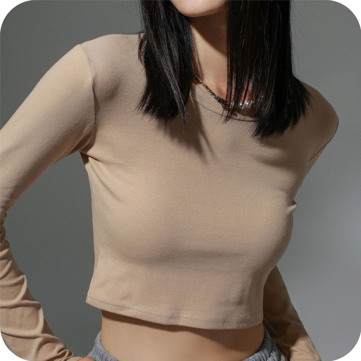 Dame figursyet langærmet crop-top i elastisk materiale med hudvenligt feel Stilla