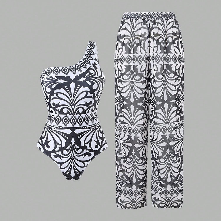 Dame one-piece badedragt med elegant asymmetrisk design og matchende bukser Skovae