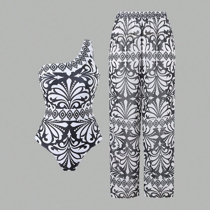 Dame one-piece badedragt med elegant asymmetrisk design og matchende bukser Skovae