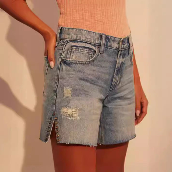 Dame Elegante Denim-Shorts med trendy Ripped-detaljer og dekorative trykknapper Stilla