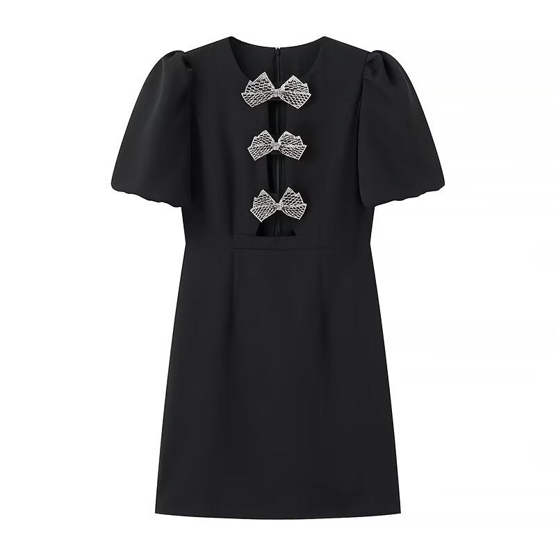 Damekjole med elegante puffærmer og dekorative sløjfer Stilla