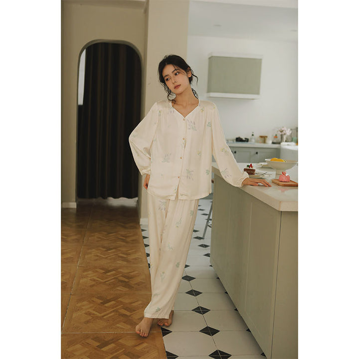 Damebluse med florale accenter og elegant knapliste Stilla