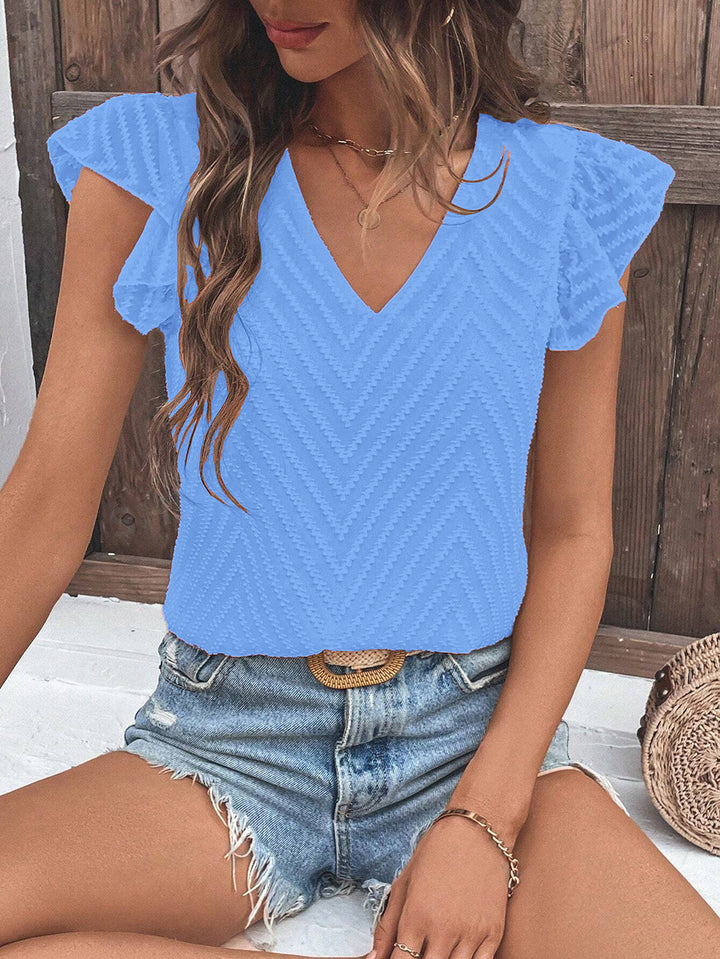 Damebluse med moderne zigzag-mønster og flæsedetaljer Stilla