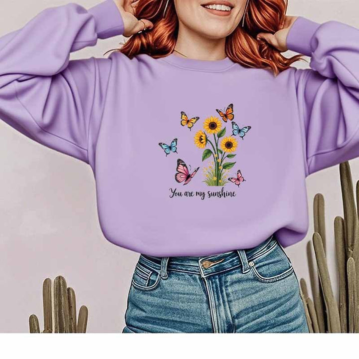 Damebluse med blomstermotiv og motiverende print Stilla