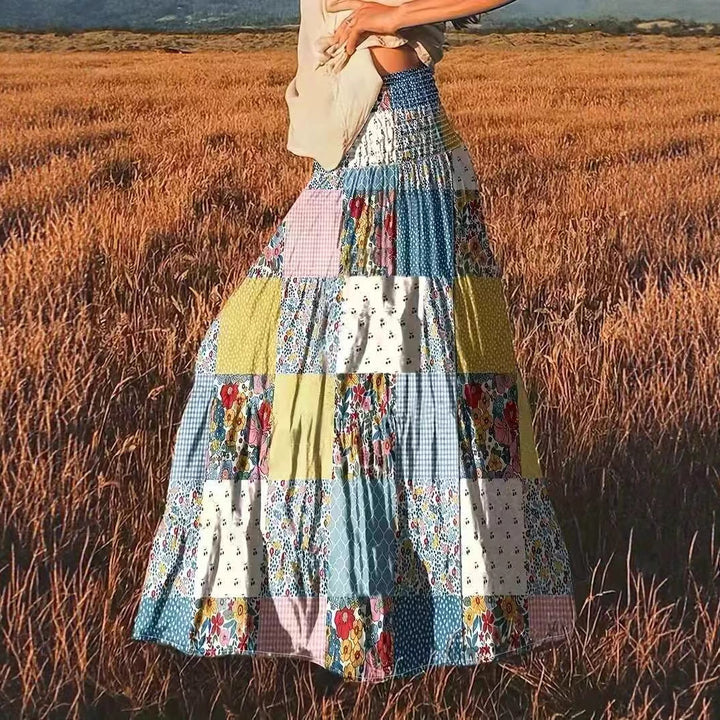 Dame maxikirtel i patchwork-design med elastisk talje og flydende snit Stilla