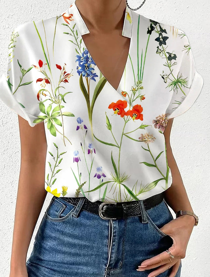 Dame elegant bluse med floralt design og subtil krave Stilla