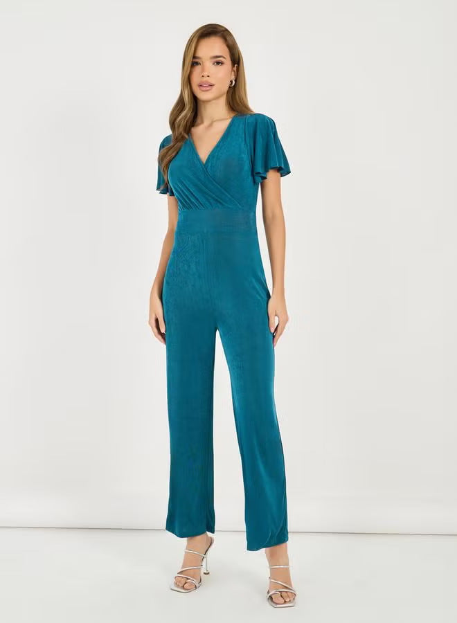 Dame elegant jumpsuit med flydende snit og detaljerede puffærmer Skovae