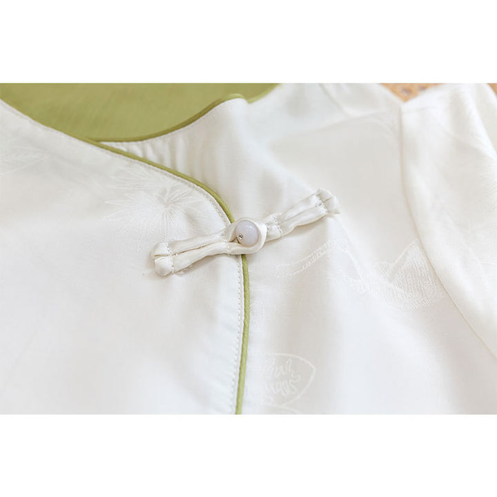 Dame bluse top med blomstret relief og elegant knaplukning Stilla