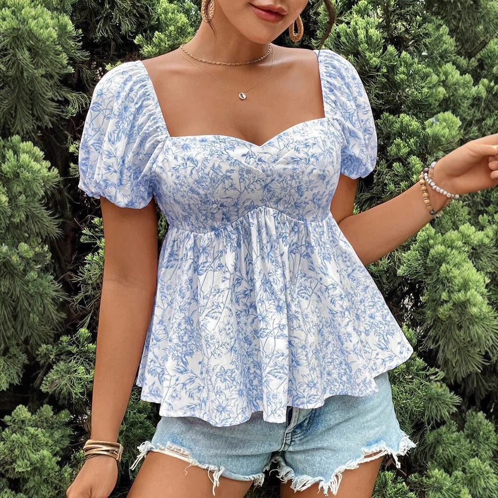 Damebluse med puffærmer og blomsterdesign Stilla