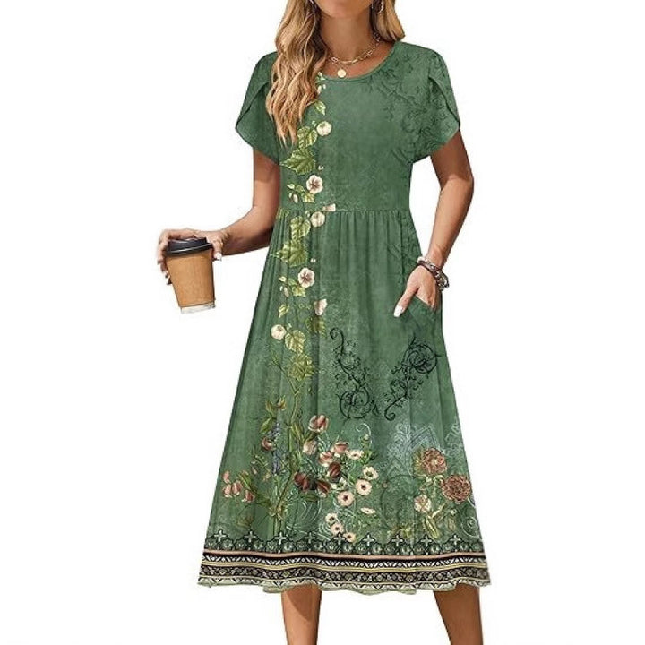 Dame flydende maxikjole med blomsterdesign og praktiske sidelommer Stilla
