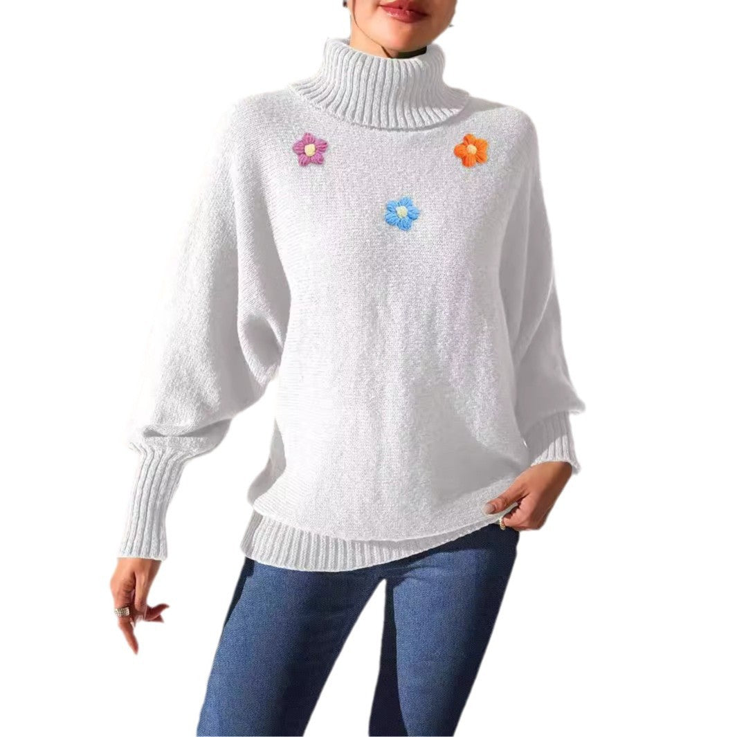 Dame moderigtigt strikpullover med høj krave og farverige blomsterapplikationer Stilla