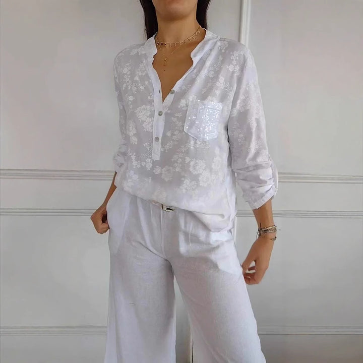 Damebluse med blomsterdesign og glitrende pailletter Stilla
