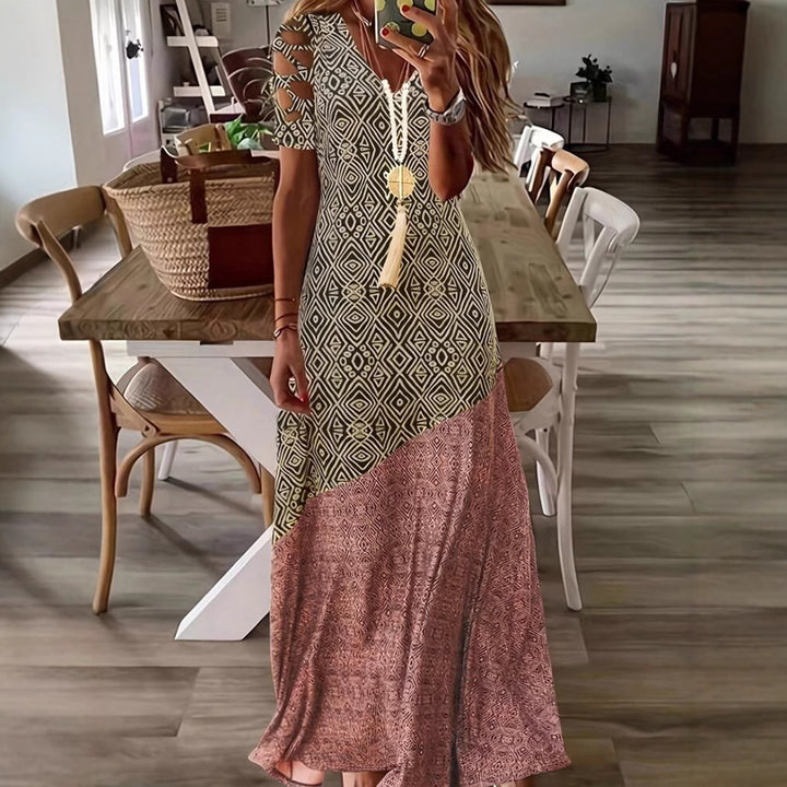 Dame Maxikjole med asymmetrisk snit og moderne cut-out-detaljer Stilla