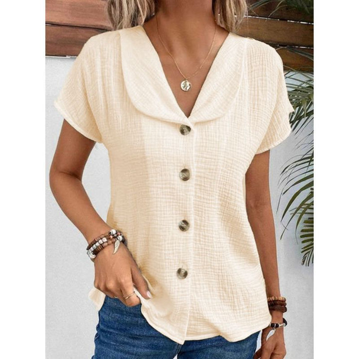 Damebluse med elegant klapkrave og dekorative knapper Stilla