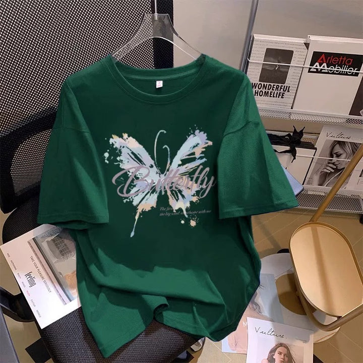 Dame T-shirt med kunstnerisk sommerfugletryk og inspirerende tekst Stilla