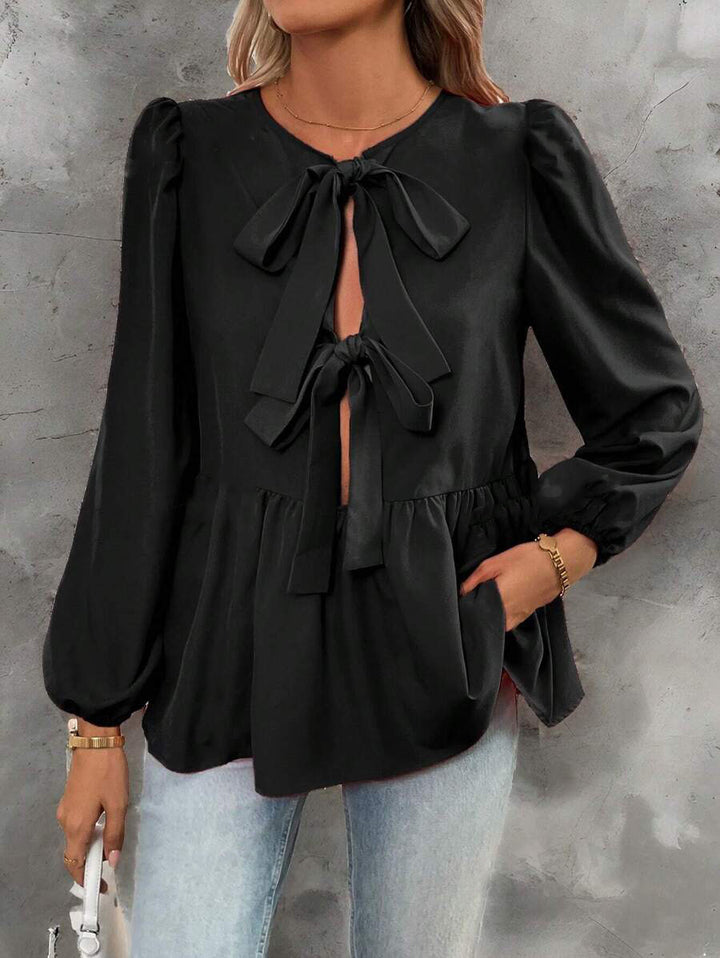 Damebluse med elegante sløjfedetaljer og voluminøse ærmer Stilla
