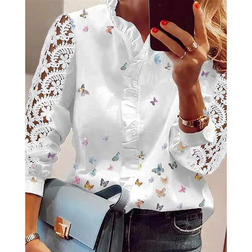 Damebluse med florale applikationer, volangdetaljer og spidsærmer Stilla
