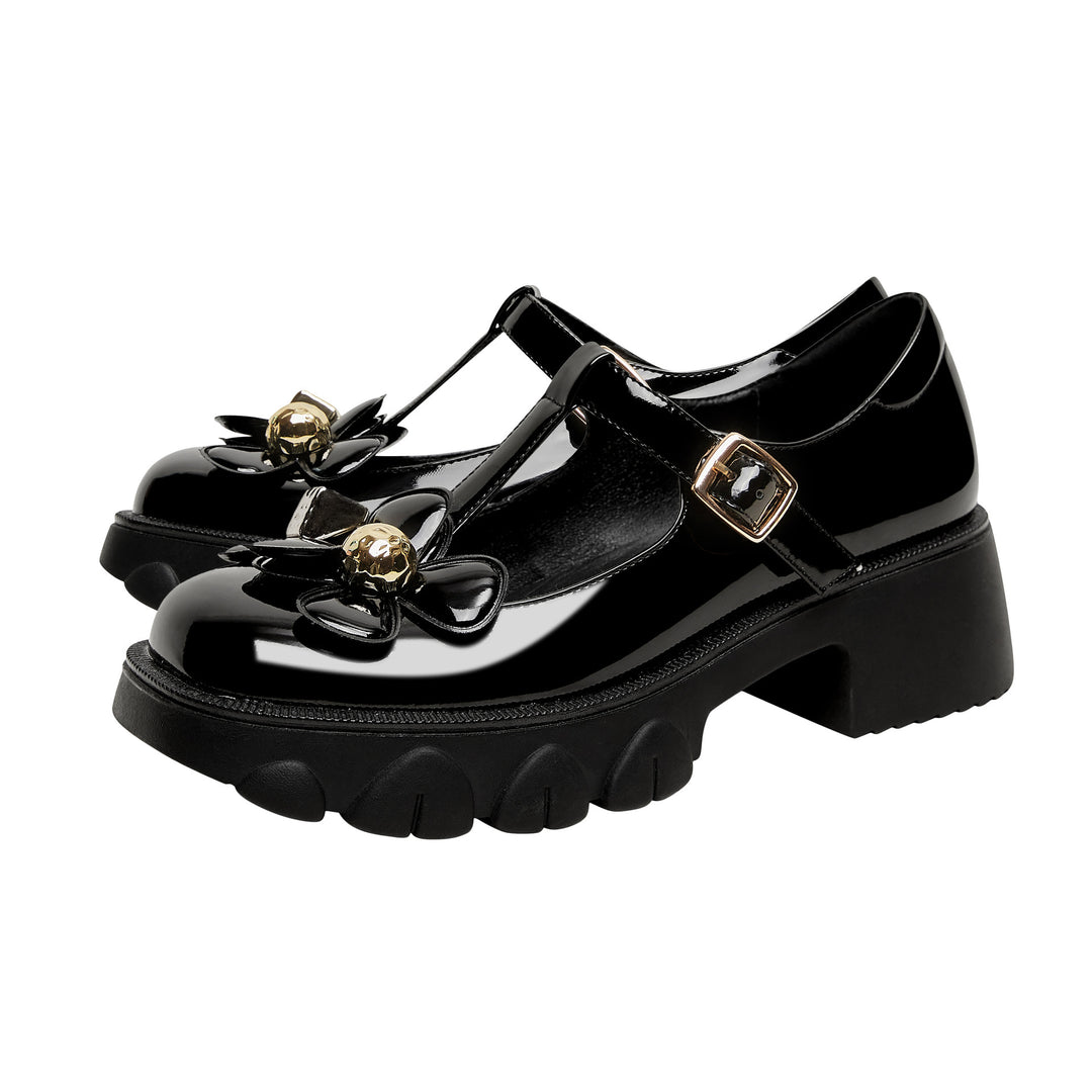 Femme Chunky Heel T-Strap Mary Jane sko med floral accent Stilla