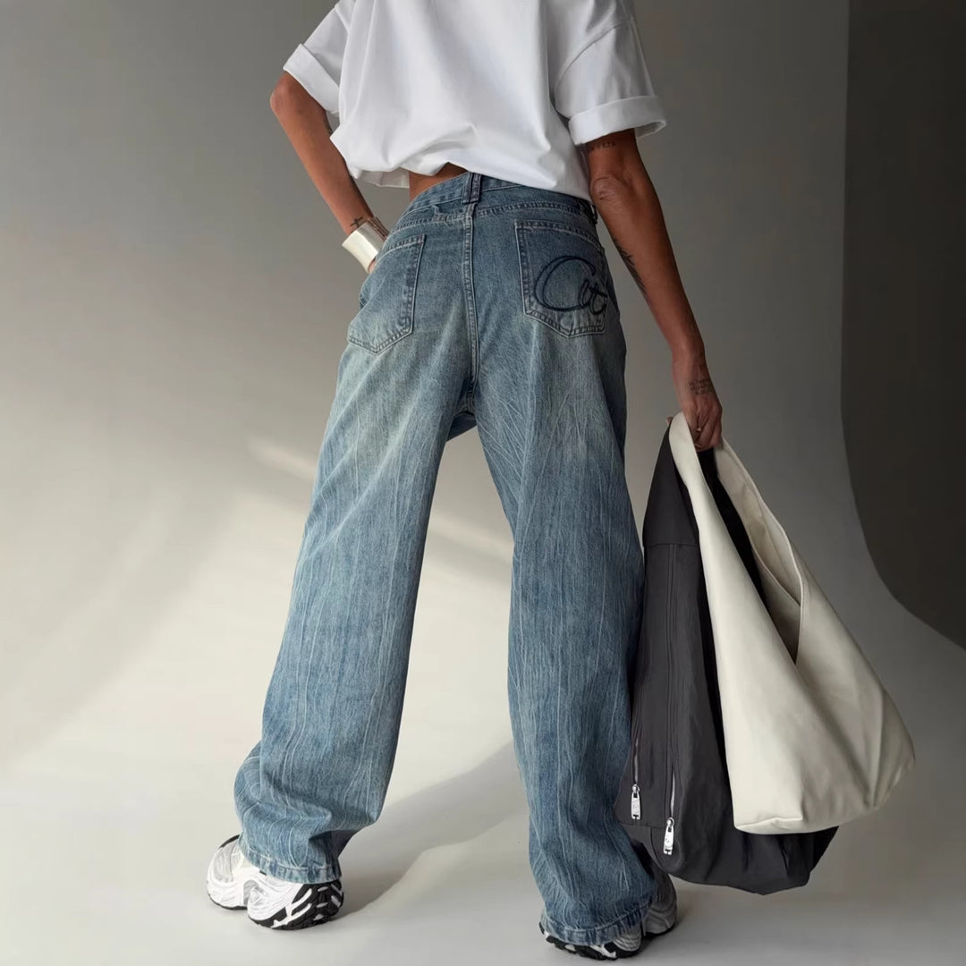 Kvinders bredskårne jeans med en continuér knapstolpe Stilla
