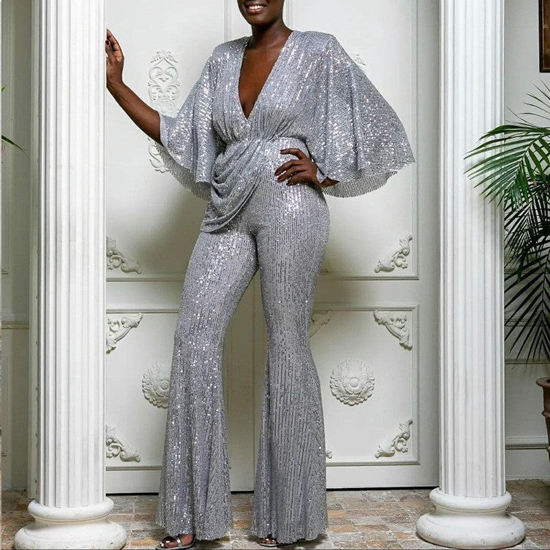 Dame glamourøs jumpsuit med glitrende paletter og vidde ben Stilla