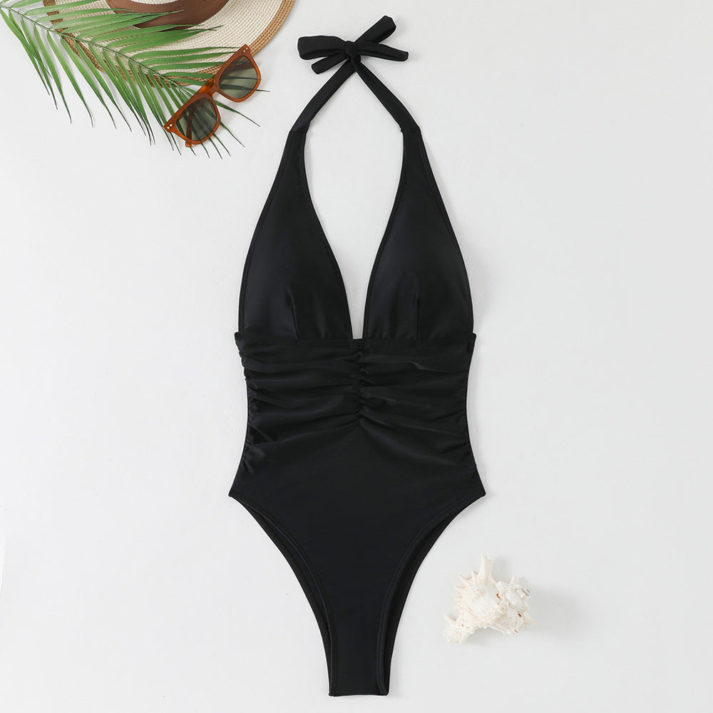 Dame one-piece badedragt med dyb V-udskæring og moderne drapering Skovae