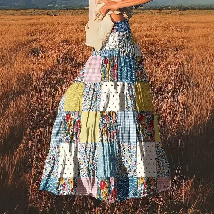 Dame maxikirtel i patchwork-design med elastisk talje og flydende snit Stilla