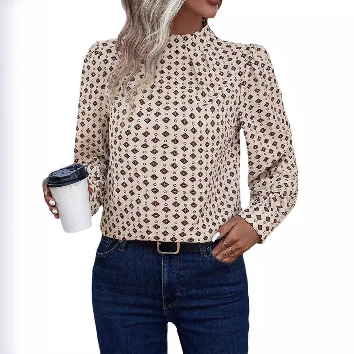 Damebluse med elegant spidsedetalje og blomstret design Stilla