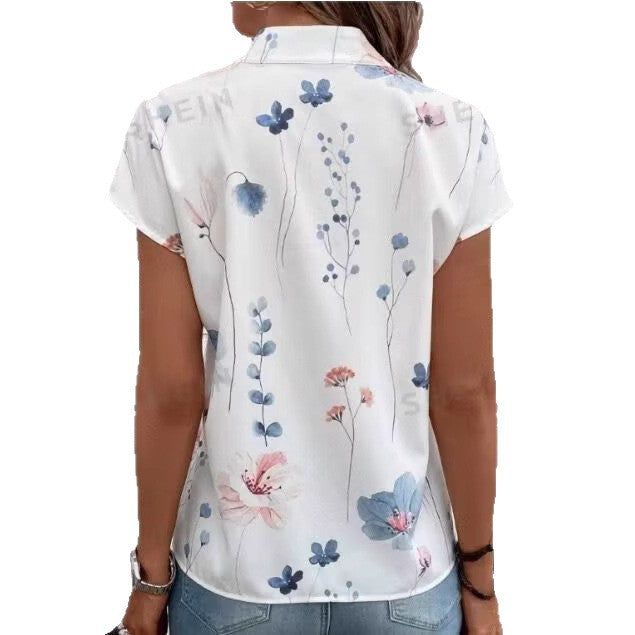 Damebluse med blomsterdesign og capærmer Stilla