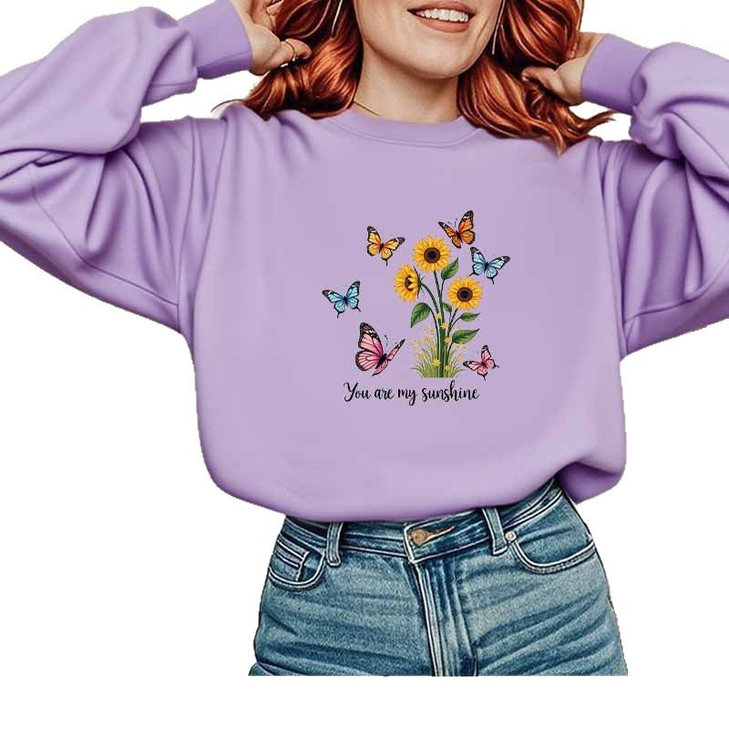 Damebluse med blomstermotiv og motiverende print Stilla