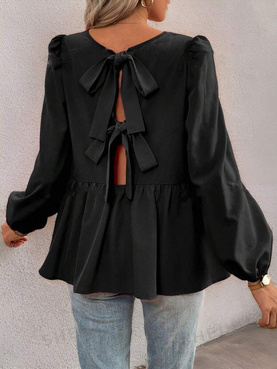 Damebluse med elegante sløjfedetaljer og voluminøse ærmer Stilla