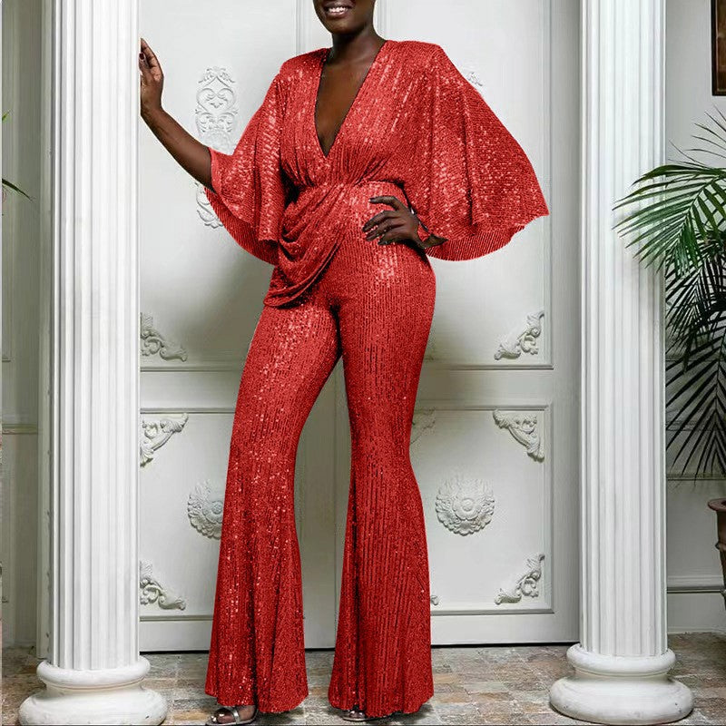 Dame glamourøs jumpsuit med glitrende paletter og vidde ben Stilla