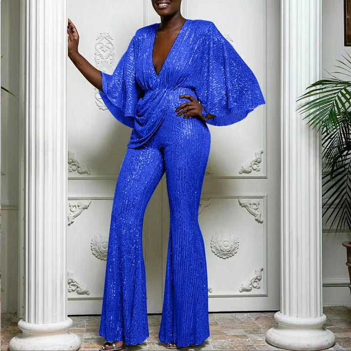 Dame glamourøs jumpsuit med glitrende paletter og vidde ben Stilla