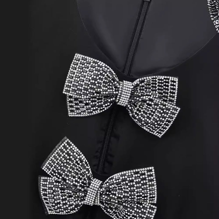 Damekjole med struktureret design og elegante sløjfeapplikationer Stilla