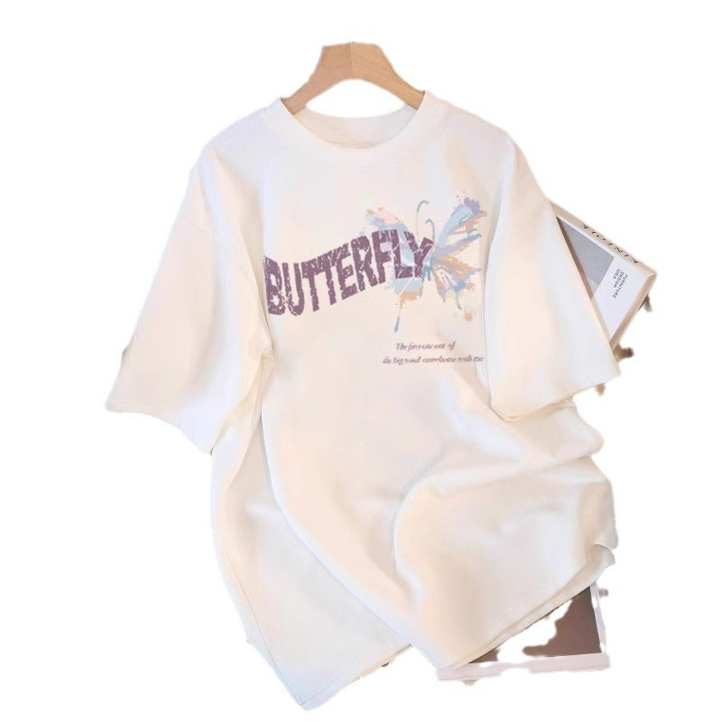 Dame T-shirt med kunstnerisk sommerfugletryk og inspirerende tekst Stilla