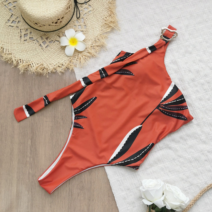 Dame én-delt badedragt med asymmetrisk snit og dekorativ ringdetalje Stilla