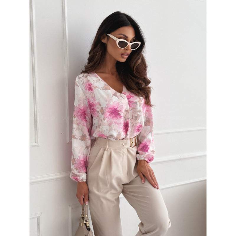 Damebluse med blomsterprint og elegante pufærmer Stilla