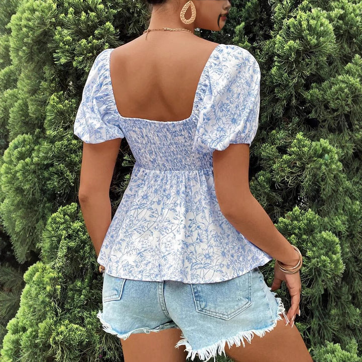 Damebluse med puffærmer og blomsterdesign Stilla