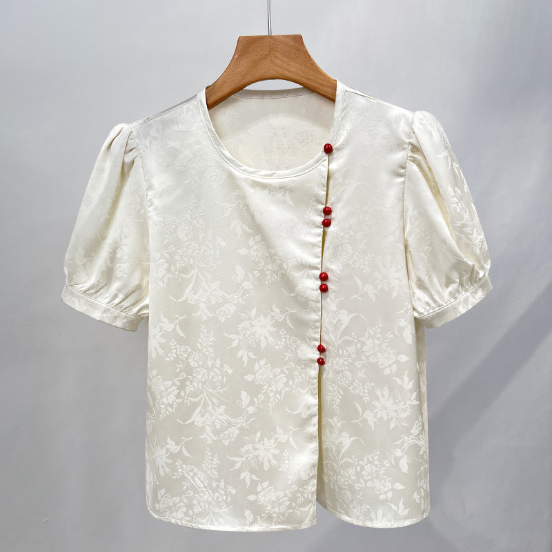 Damebluse med elegant struktur og dekorative knapper Stilla