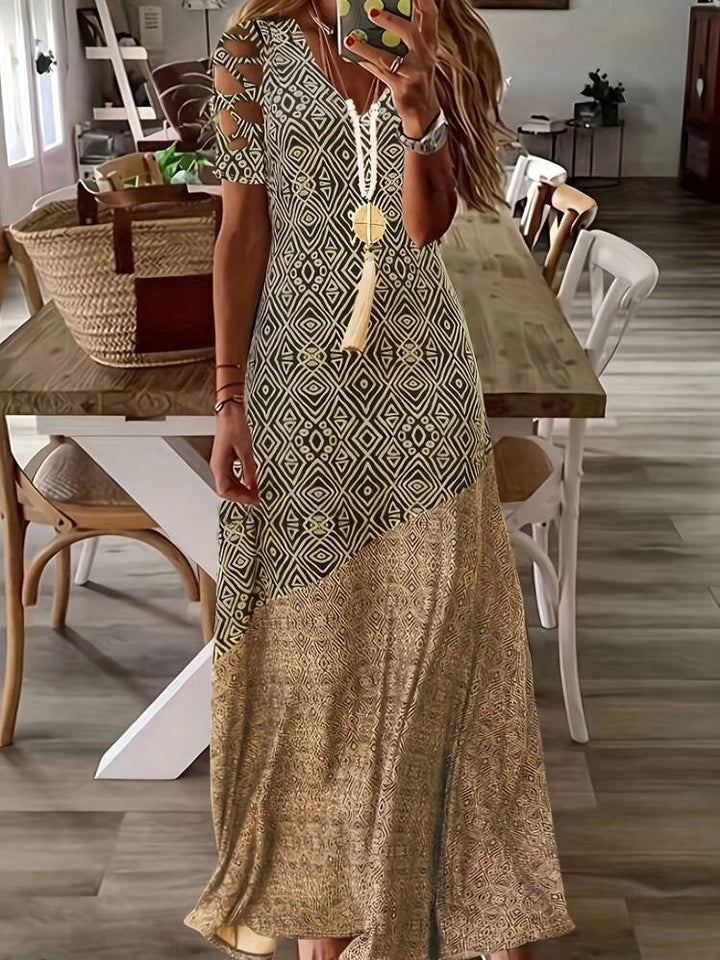 Dame Maxikjole med asymmetrisk snit og moderne cut-out-detaljer Stilla