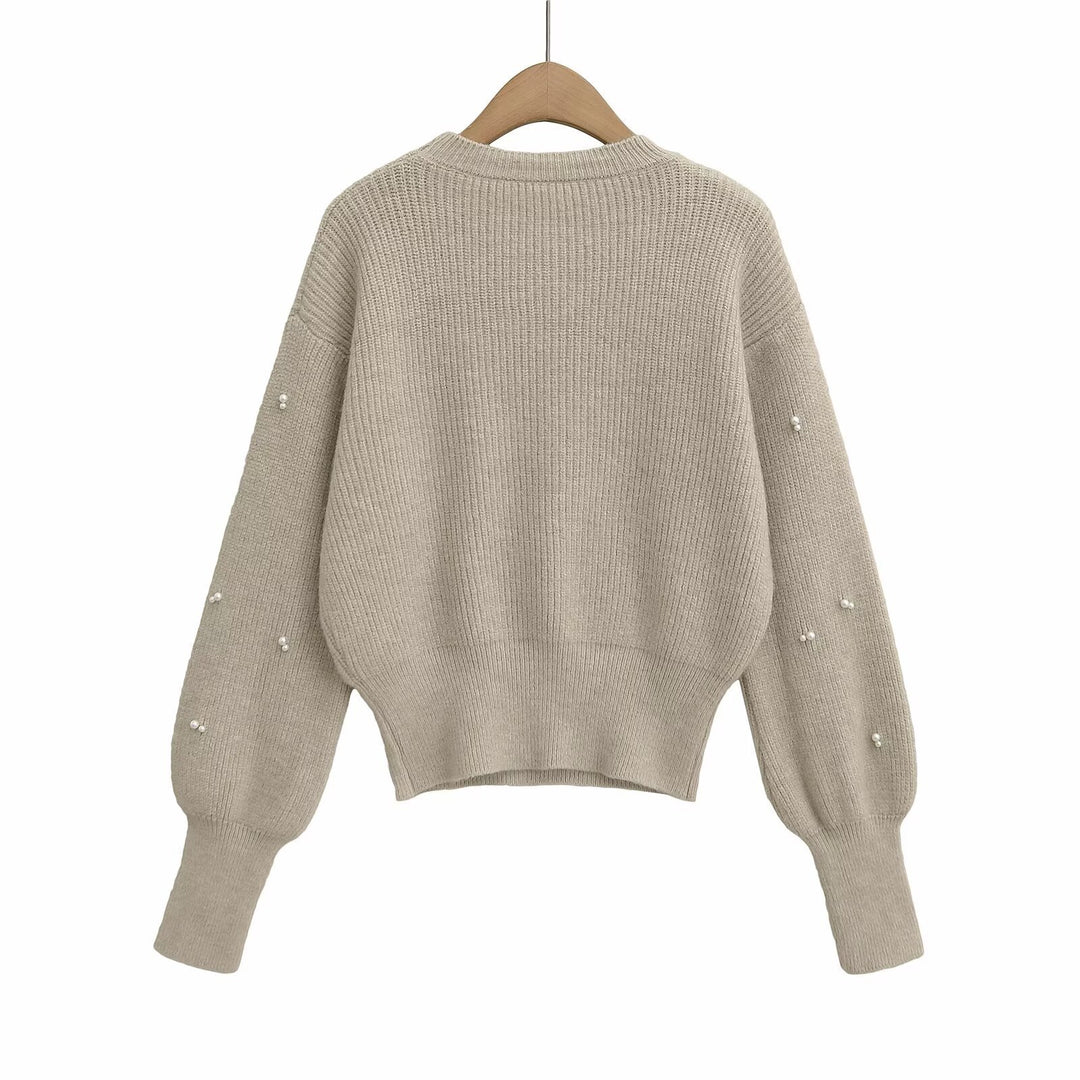 Dame modisk strikpullover med elegante perledetaljer Stilla