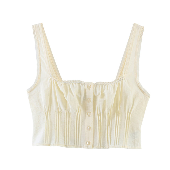 Dame-crop-top med fine folder og dekorknapper Skovae