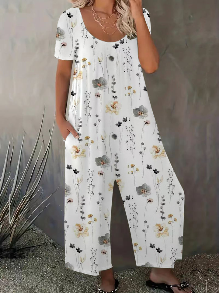 Damer bred blomster-jumpsuit med lommer og bådudskæring Stilla