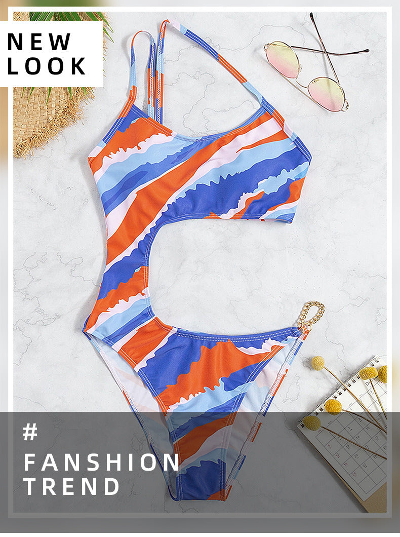 Dame one-piece badedragt med asymmetrisk snit og guldfarvede accenter Skovae